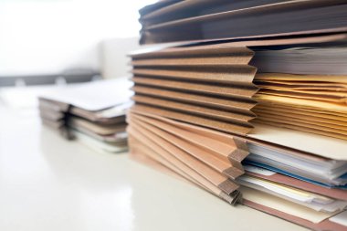 Office files stacked on shelf and organized for storage or archive