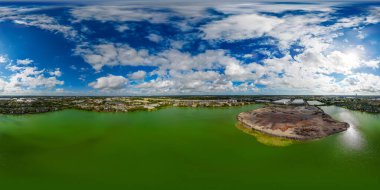 Aerial 360 equirectangular photo of a quary man made lake with green water