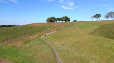 Aerial video drone flying up a hill in a park