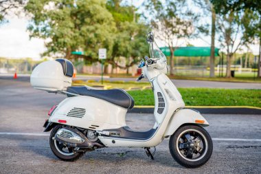 Sunrise, FL, USA - January 8, 2022: Photo of a 2015 Vespa GTS Super 300 outdoors in a park scene