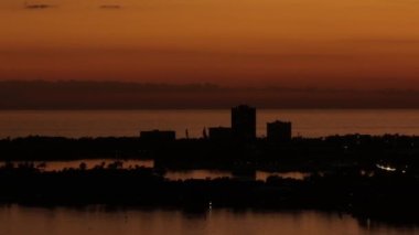 Aerial sweeping video orange sunset silhouette Sarasota Florida