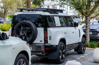 Coral Gables, FL, USA - January 28, 2023: Photo of a white Land Rover Defender 110 all wheel drive SUV