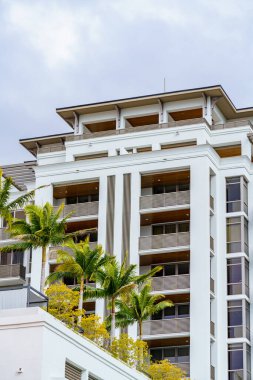 Coral Gables, FL, USA - January 28, 2023: Photo of modern condominium buildings in Coral Gables with palm trees