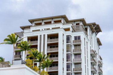 Coral Gables, FL, USA - January 28, 2023: Photo of modern condominium buildings in Coral Gables with palm trees