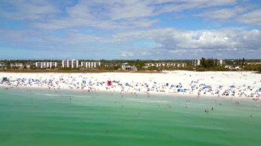 Aerial rise reveal tourists on Siesta Key Sarasota Beach Florida USA