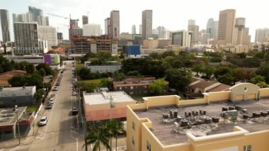 Aerial video Overtown to Downtown Miami. Drone flying and tilting up to view skyscrapers