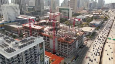 Block 55 construction site circa February 2023. Aerial drone video Miami developments near highway