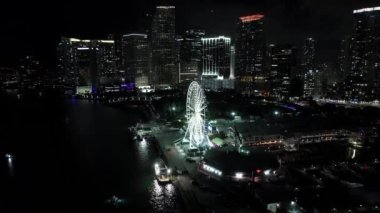Aerial night video Skyviews Miami ferris wheel ride at Bayside Marketplace