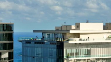 Aerial video construction workers on highrise tower skyscraper top floor