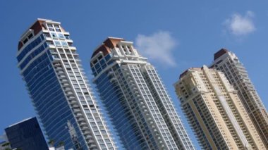 8k dutch tilt video highrise towers on blue sky with clouds
