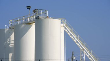 8k video white industrial silos with ladder