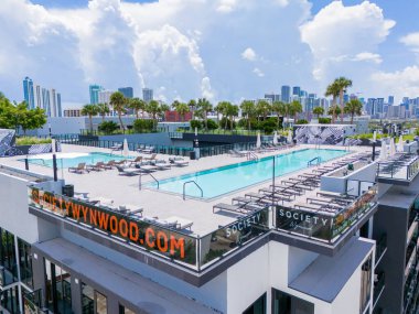 Miami, FL, USA - August 22, 2024: Aerial photo Society Wynwood apartment building with rooftop swimming pool and lounge areas clipart