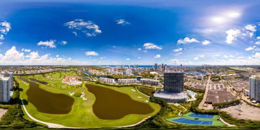 Hallandale Beach, FL, USA - September 25, 2024: Aerial 360 equirectangular VR photo of Slate Hallandale residential rental apartment building clipart