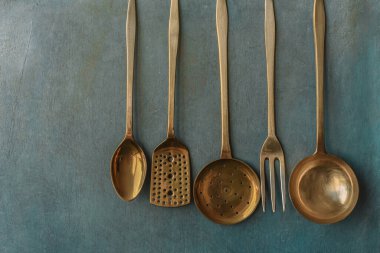 Old brass kitchen utensil on the wall