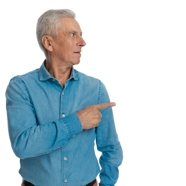 Portrait Curious Old Guy Casual Jeans Shirt Looking Pointing Finger — Stock Photo, Image