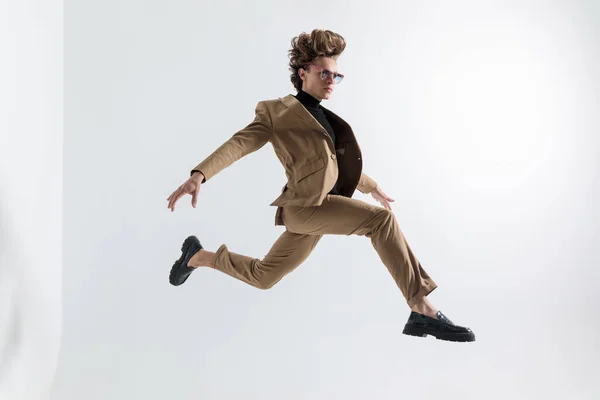 Good Looking Young Man Suit Sunglasses Leaping While Holding Arms — Stock Photo, Image