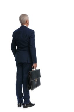full body picture and a rear view of an old business man waiting in line with his briefcase in hand