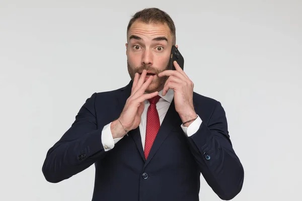 Shocked Businessman Suit Talking Phone Covering Mouth Being Surprised Grey — Zdjęcie stockowe
