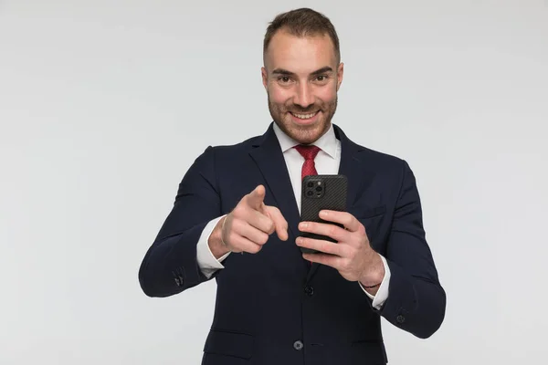 Attractive Young Businessman Scrolling Social Media Smiling Pointing Finger Front — Zdjęcie stockowe