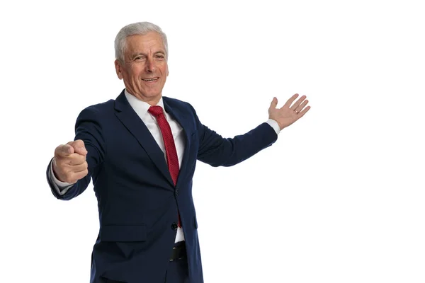 Old Businessman Pointing Finger Camera While Pointing Other Hand Side — Stockfoto