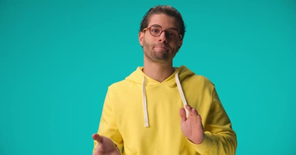 Bored Young Man Glasses Wearing Yellow Hoodie Applauding Boring Show — Vídeo de stock