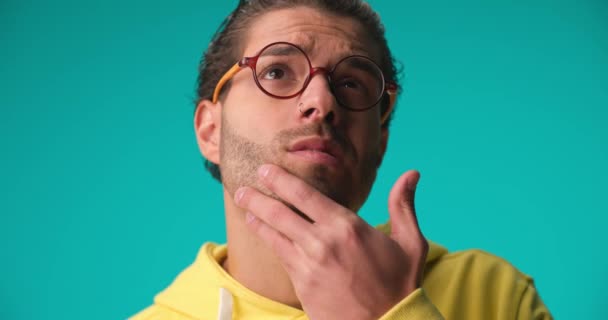 Thoughtful Lebanese Young Man Curly Hair Glasses Touching Chin Thinking — Vídeos de Stock