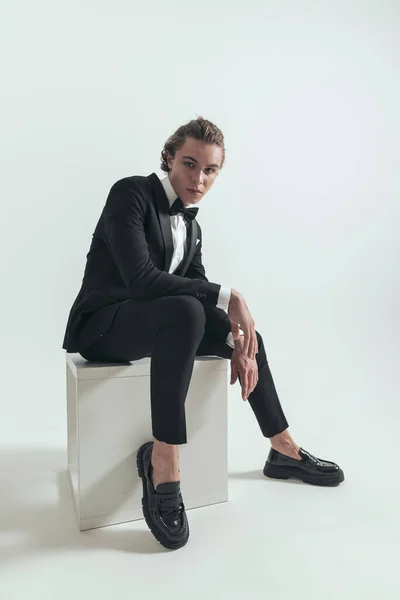 Elegant Seated Man Black Tuxedo Holding Elbows Knees Posing Front — Stock Photo, Image