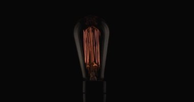 lightbulb turning on, moving filaments and illustrating the concept of thinking and having original ideas, finding a great source of inspiration