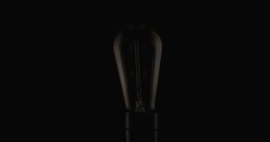 project video of light bulb slightly turning on, saving energy because the prices are high with the impossibility of paying the bills