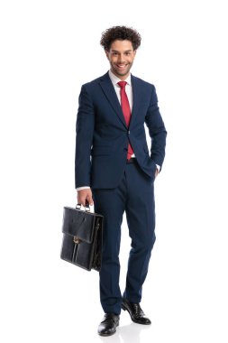full body picture of turkish businessman with hand in pocket smiling and posing in front of white background in studio