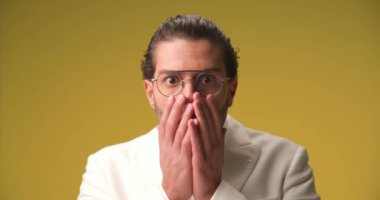 handsome businessman is in shock and cannot believe the facts then turning to disgust and anger