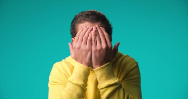 Young Casual Man Covering His Face Peeking Trough His Fingers — Vídeos de Stock