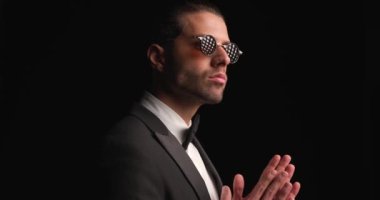 businessman rubbing palms, giving a deep look then all of a sudden turning around