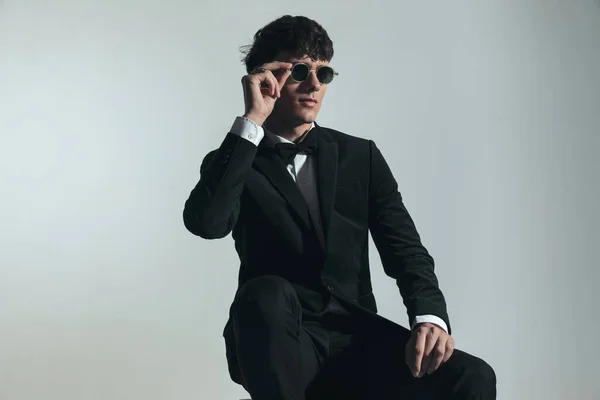 Portrait Sexy Young Groom Black Tuxedo Looking Side Adjusting Sunglasses — Stock Photo, Image