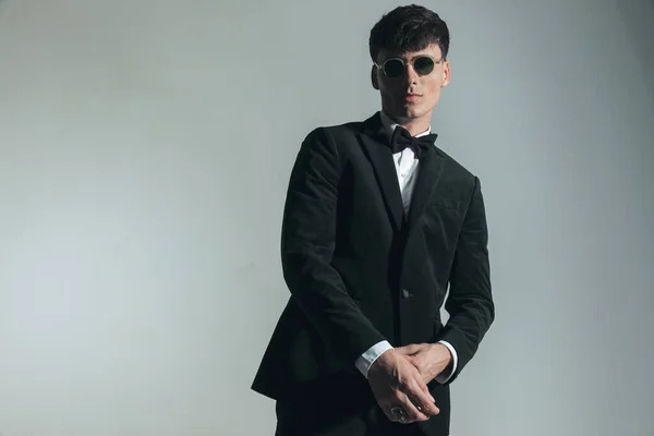 Portrait Elegant Young Guy Black Tuxedo Glasses Adjusting Sleeve Posing — Stock fotografie