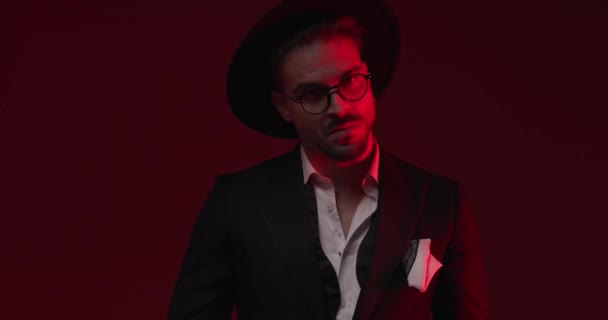 Mysterious Bearded Man Suit Hat Glasses Posing Red Blue Lights — Video