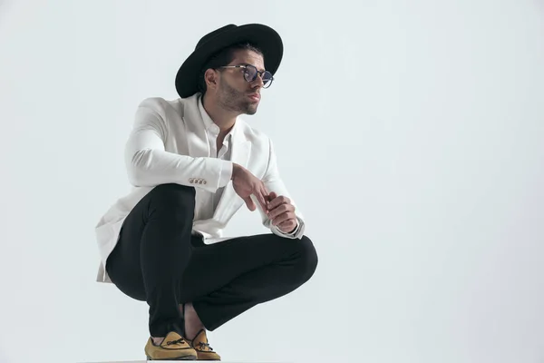 Sexy Attractive Young Man Hat Glasses Crouching Looking Side While — стоковое фото