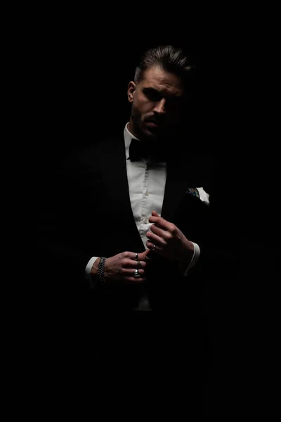 Stylish Elegant Man Adjusting Unbuttoning Black Tuxedo Front Black Background — Stock Photo, Image
