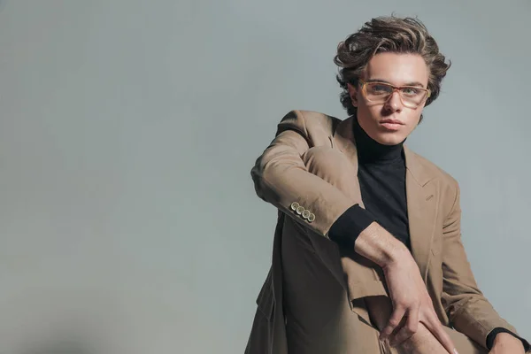 Attractive Man Beige Suit Turtleneck Glasses Holding Knee While Sitting — Stock Photo, Image