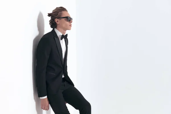 Elegant Businessman Black Tuxedo Sunglasses Laying Wall Looking Side Grey — Stock Photo, Image