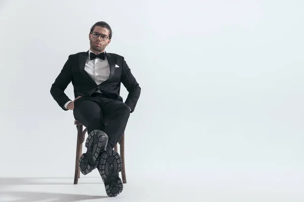 Confiado Hombre Elegante Esmoquin Negro Sentado Con Las Manos Los — Foto de Stock