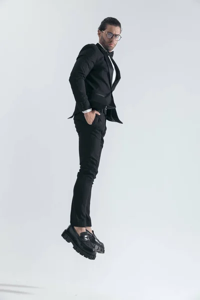 Elegant Groom Black Tuxedo Jumping Air Hands Pockets Front Grey — Stock Photo, Image