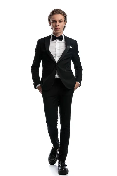 Elegant Businessman Walking Hands Pockets Wearing Formal Outfit White Studio — Stock Photo, Image
