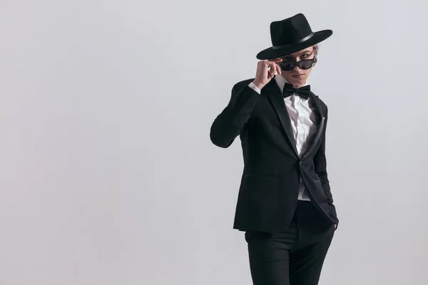 Elegant Young Groom Black Tuxedo Wearing Hat Adjusting Sunglasses Standing — Stock Photo, Image