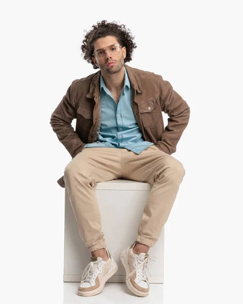 Confident Curly Hair Guy Beige Jacket Holding Hands Pockets Posing — Stock Photo, Image