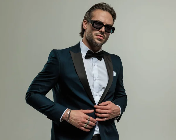 Sexy Young Man Sunglasses Looking Forward Adjusting Tuxedo While Posing — Stock Photo, Image