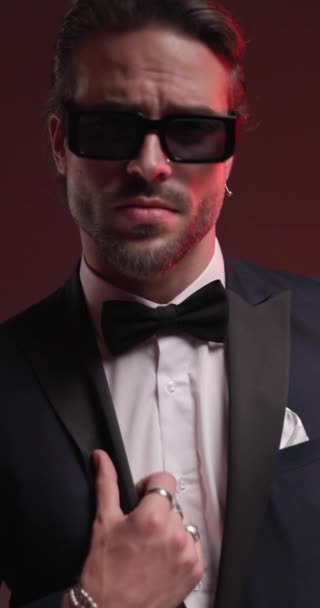 Sexy Bearded Guy Sunglasses Fixing Tuxedo Looking Side Touching Chin — Stock Video