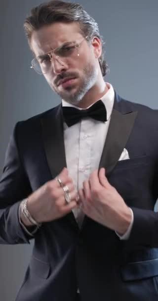 Handsome Fashion Guy Glasses Looking Away Arranging Tuxedo Sensually Touching — Stock Video