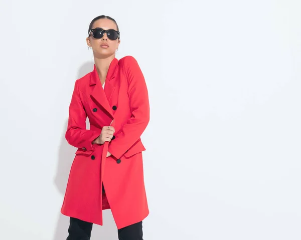 Sexy Young Woman Sunglasses Adjusting Red Coat Posing Front White — Stock Photo, Image