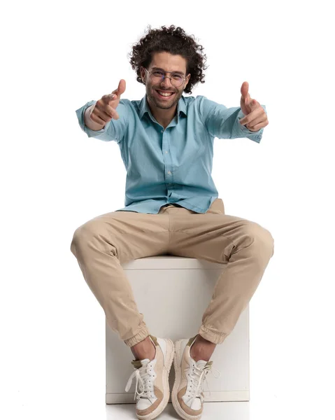 Joyful Casual Man Sitting Chair White Background Making Thumbs Sign — Stock Photo, Image